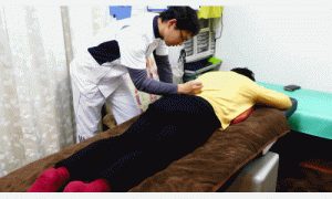 腰椎が分離している所をトントンと叩打する